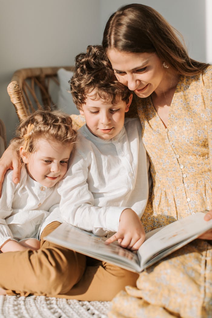 A loving mother reads a book with her children, capturing a nurturing family moment.